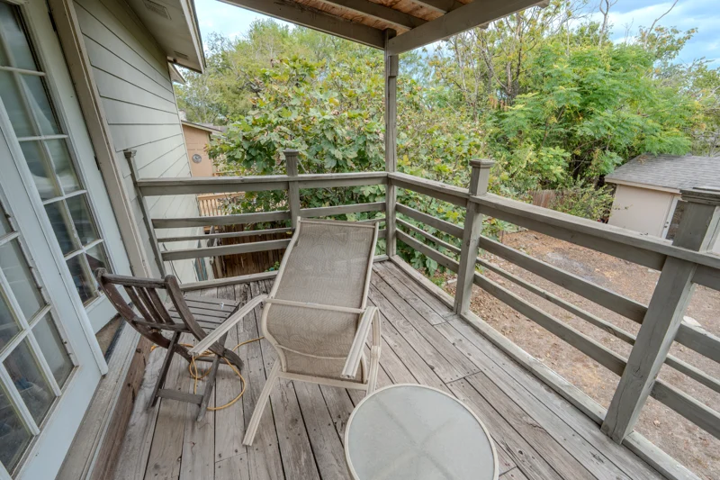 Covered wooden balcony with seating and views into the garden