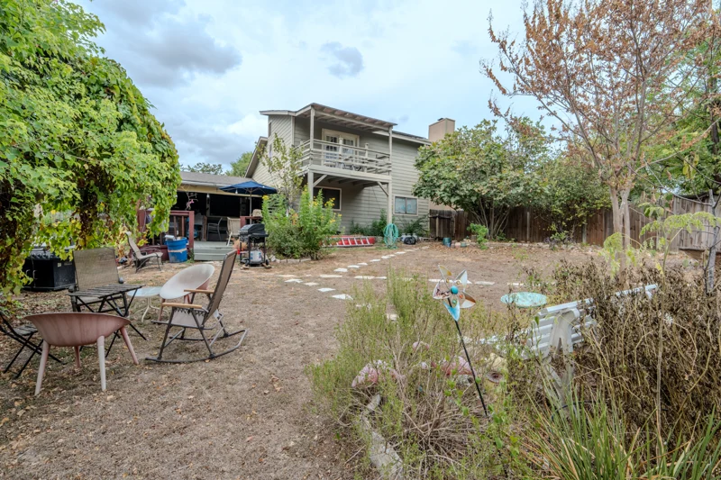 Rear garden with a view back toward the house and balcony